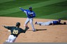 Phoenix, AZ, USA; Kansas City Royals shortstop Yuniesky Betancourt (center) completes a double play assisted by shortstop Alcides Escobar (far right) as Oakland Athletics catcher Josh Donaldson (20) runs to second base during the fifth inning at Phoenix Municipal Stadium. Mandatory Credit: Kyle Terada-US PRESSWIRE